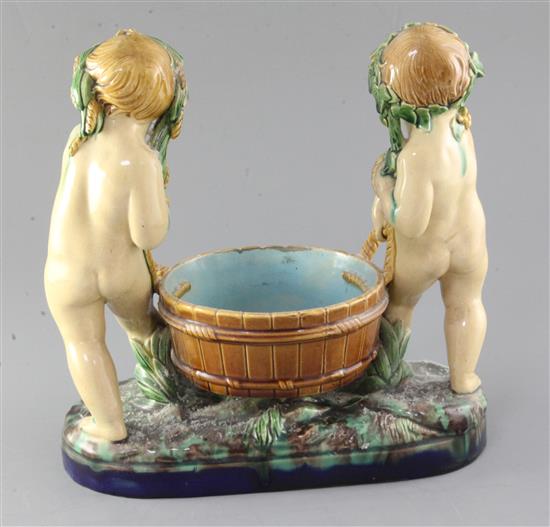 A Victorian Minton majolica group of two putti carrying a wooden tub, width 28cm height 27cm